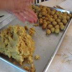 Almond paste on a baking sheet. Some of the paste has been shaped into balls.